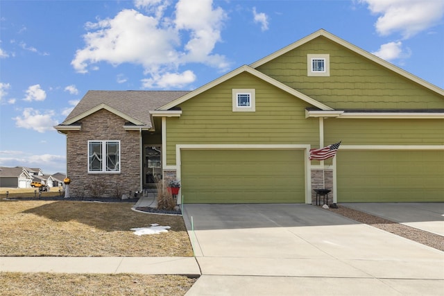 craftsman-style home featuring concrete driveway, an attached garage, and stone siding