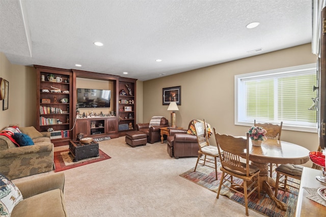 living room with recessed lighting, visible vents, carpet, and a textured ceiling