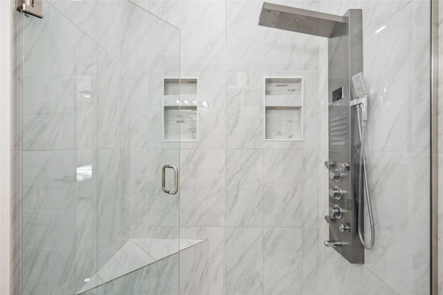 full bathroom featuring a marble finish shower