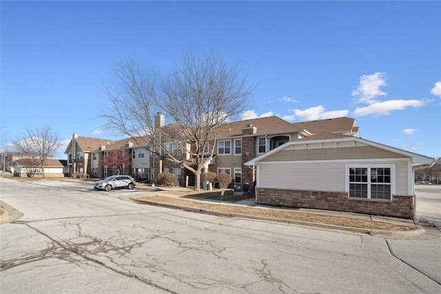 view of front of property featuring stone siding and a residential view