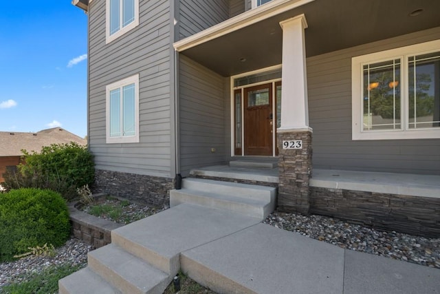 view of exterior entry featuring a porch