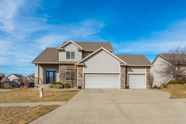 view of front of home featuring a front lawn, stone siding, concrete driveway, an attached garage, and a shingled roof