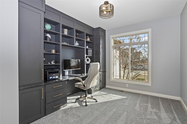 carpeted home office featuring baseboards