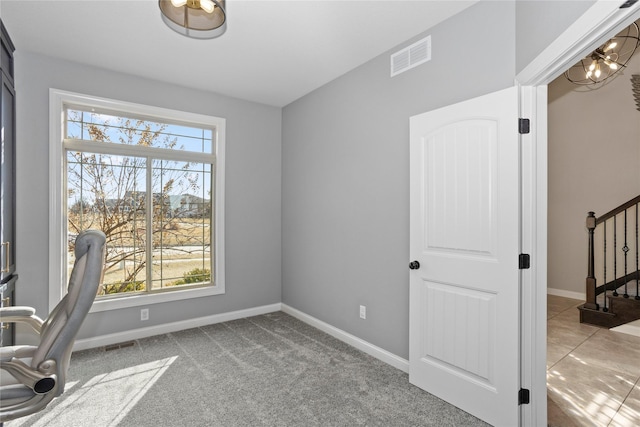 carpeted office space with a wealth of natural light, visible vents, and baseboards