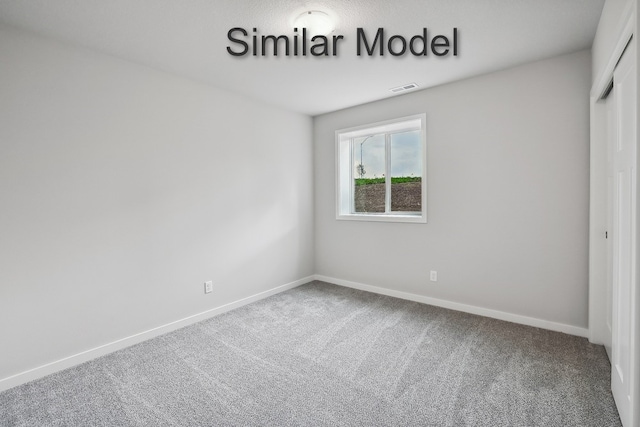 unfurnished bedroom featuring a closet, visible vents, baseboards, and carpet floors