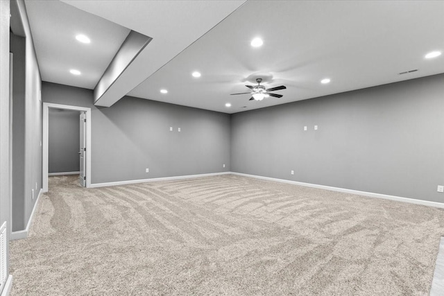 spare room featuring light carpet, recessed lighting, ceiling fan, and baseboards