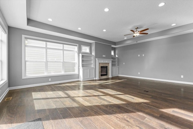 unfurnished living room with recessed lighting, baseboards, wood finished floors, and a tile fireplace