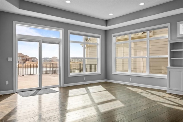 interior space with baseboards and dark wood-style flooring