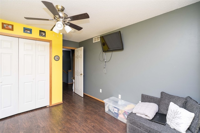 unfurnished room featuring visible vents, baseboards, wood finished floors, a textured ceiling, and a ceiling fan