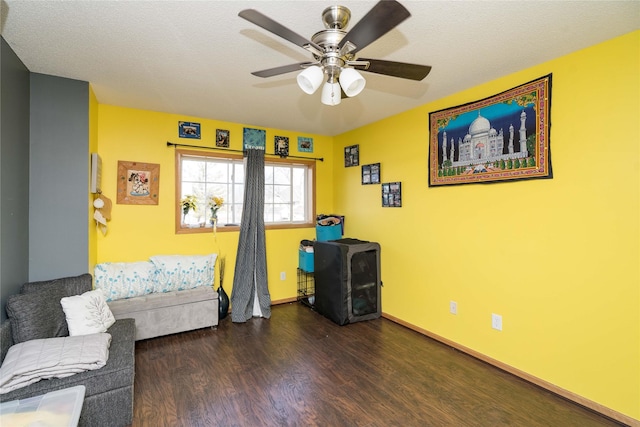 bedroom with ceiling fan, baseboards, a textured ceiling, and wood finished floors