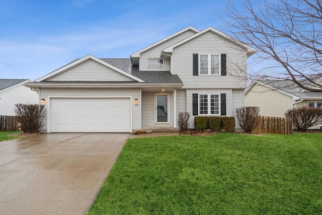 traditional-style home with driveway, a front yard, an attached garage, and fence