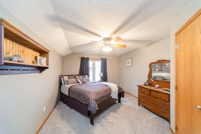 bedroom with baseboards, ceiling fan, vaulted ceiling, a textured ceiling, and light carpet