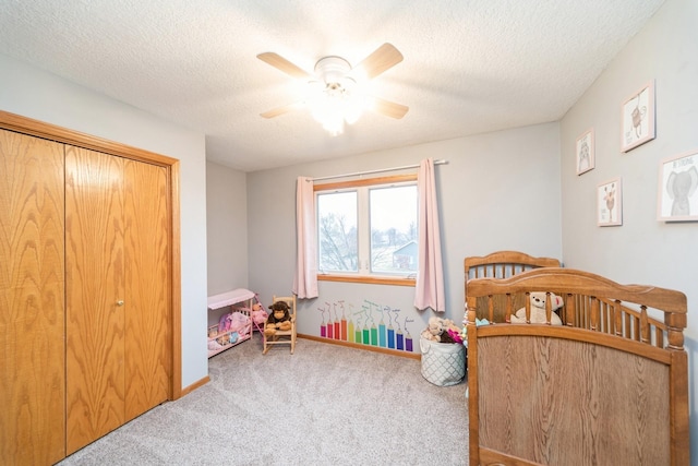 bedroom featuring baseboards, a textured ceiling, a ceiling fan, and carpet