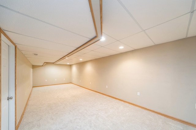 finished below grade area with recessed lighting, baseboards, a paneled ceiling, and carpet flooring