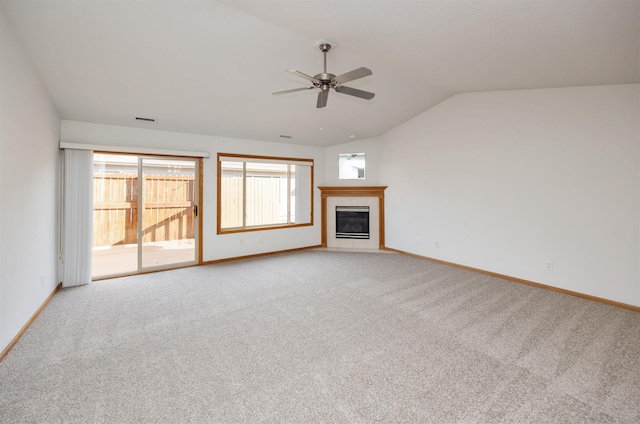 unfurnished living room featuring baseboards, lofted ceiling, light colored carpet, and a fireplace