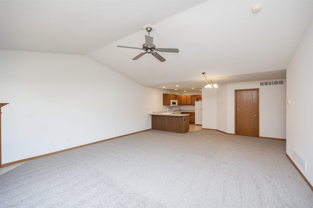 unfurnished living room with light carpet, visible vents, baseboards, and lofted ceiling