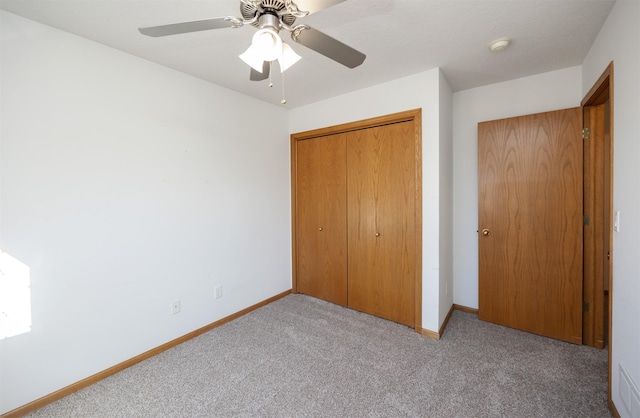 unfurnished bedroom with a closet, ceiling fan, baseboards, and carpet floors