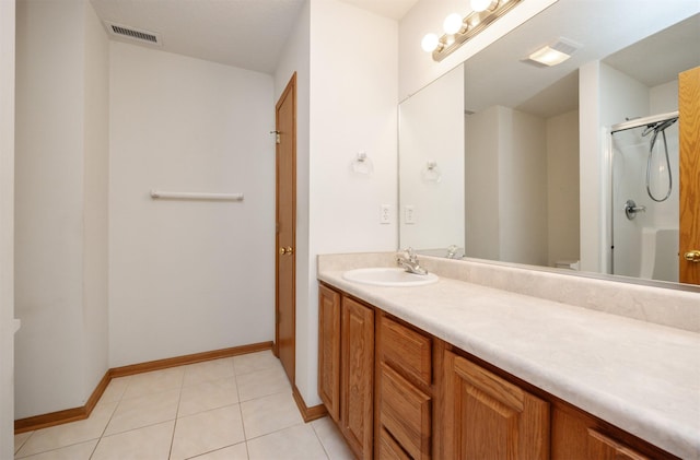 full bath with vanity, baseboards, visible vents, a shower stall, and tile patterned floors