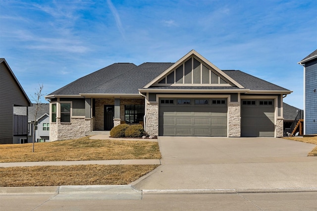 craftsman-style house featuring an attached garage, stone siding, driveway, and a shingled roof