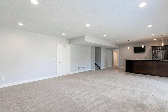 unfurnished living room with stairway, recessed lighting, and baseboards