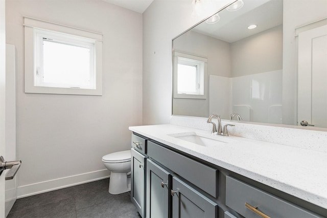 bathroom featuring tile patterned floors, baseboards, toilet, and vanity