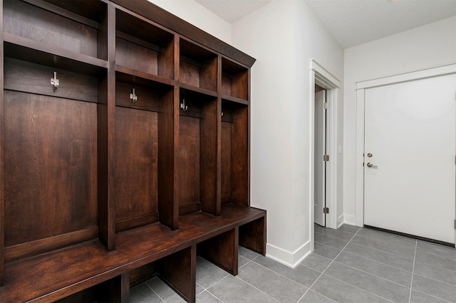 mudroom featuring tile patterned floors and baseboards