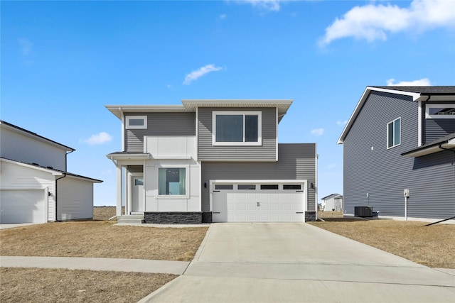 view of front facade with concrete driveway, cooling unit, and a garage