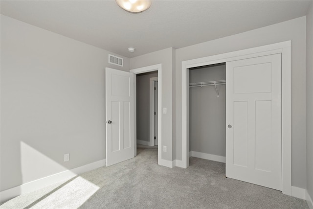 unfurnished bedroom featuring carpet, visible vents, and baseboards