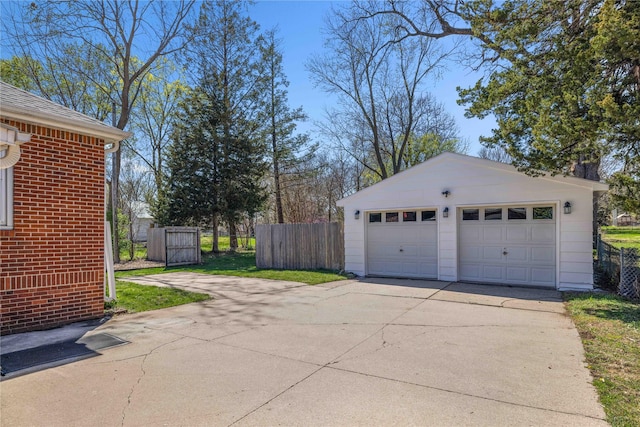 detached garage featuring fence