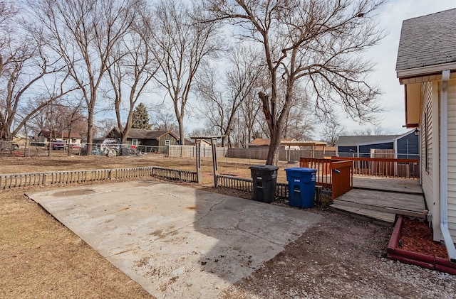 view of patio featuring a wooden deck and a fenced backyard