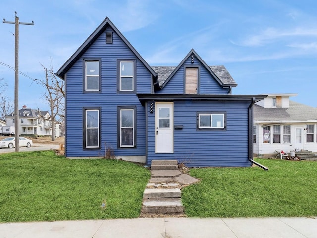 view of front of house featuring entry steps and a front lawn