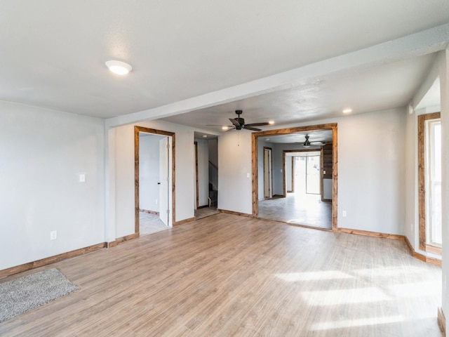 unfurnished room featuring light wood-style flooring, baseboards, and ceiling fan