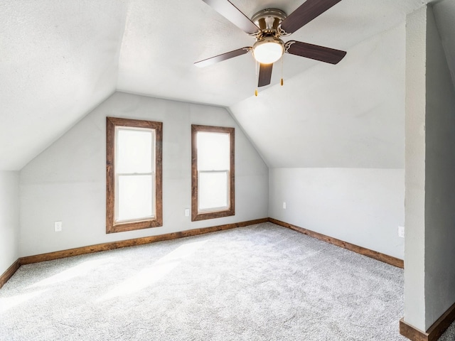 bonus room with baseboards, carpet floors, and vaulted ceiling