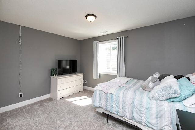 bedroom featuring light colored carpet, baseboards, and visible vents