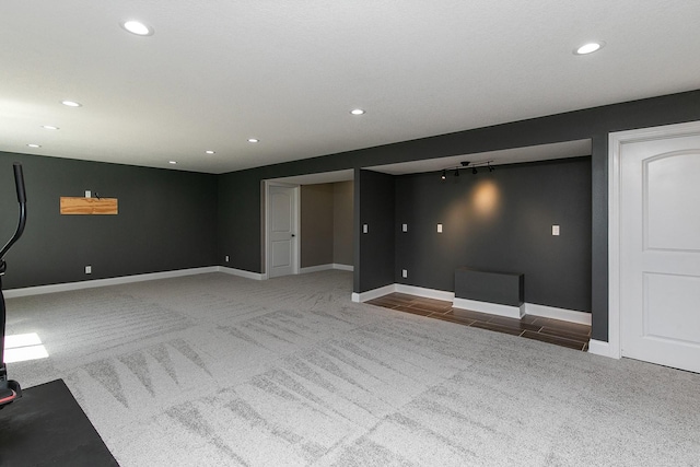 unfurnished living room featuring recessed lighting, carpet, and baseboards