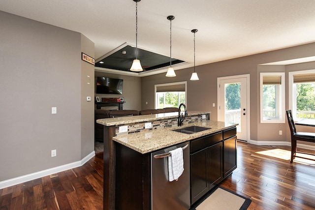 kitchen with a sink, decorative light fixtures, an island with sink, dark wood-style floors, and stainless steel dishwasher