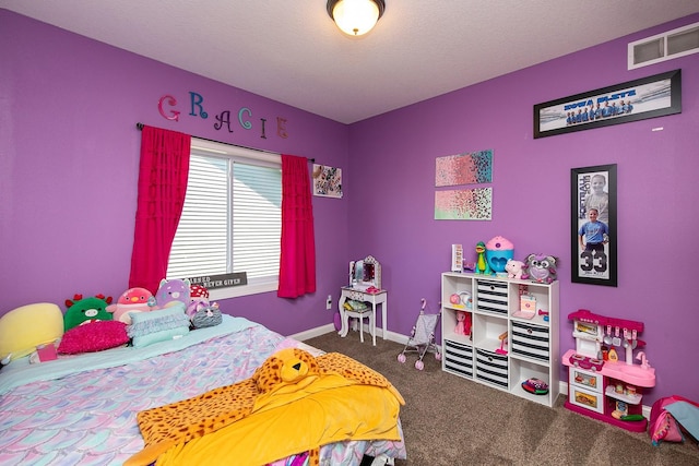 carpeted bedroom featuring visible vents, baseboards, and a textured ceiling