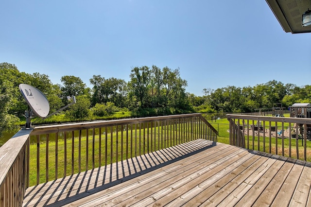 deck with a playground and a yard