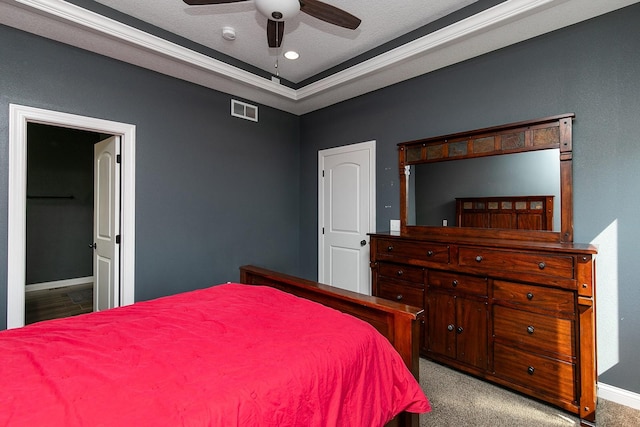 bedroom featuring visible vents, baseboards, ornamental molding, carpet flooring, and a textured ceiling