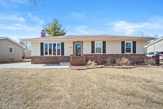 ranch-style home featuring a front lawn, brick siding, and a chimney