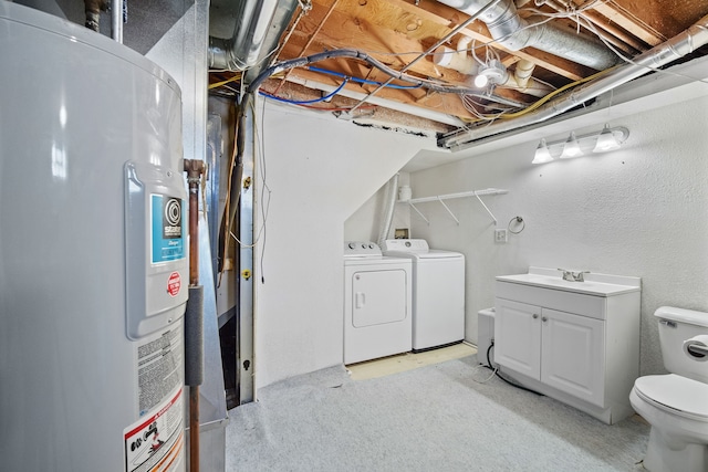 unfinished basement with a sink, water heater, and washing machine and clothes dryer