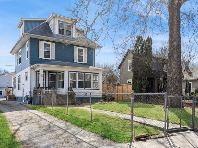 traditional style home featuring a fenced front yard, a front lawn, and a gate