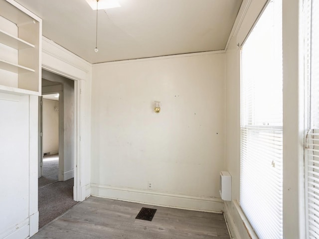 empty room with wood finished floors and baseboards