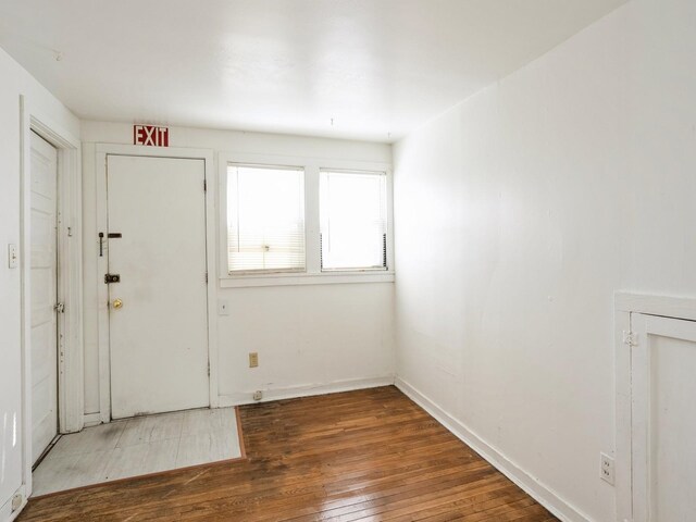 foyer featuring baseboards and wood-type flooring