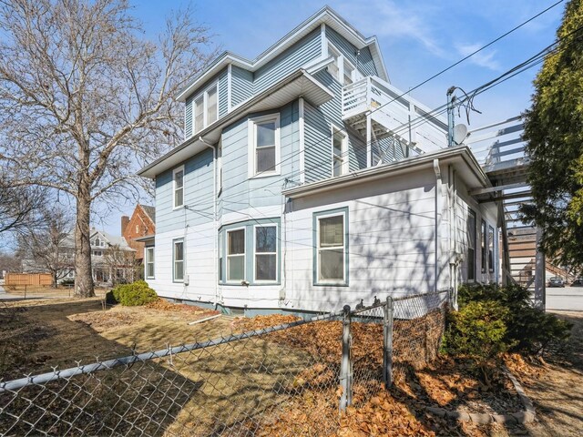 view of side of home with a fenced front yard