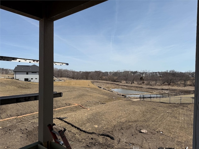 view of yard with fence and a water view