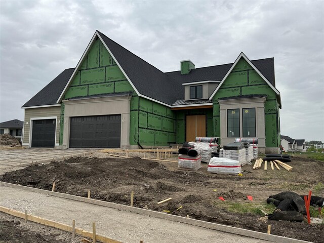 18241 Baxter Pl, Clive, IA 50325 - property in mid-construction featuring a garage, a standing seam roof, metal roof, driveway, and roof with shingles
