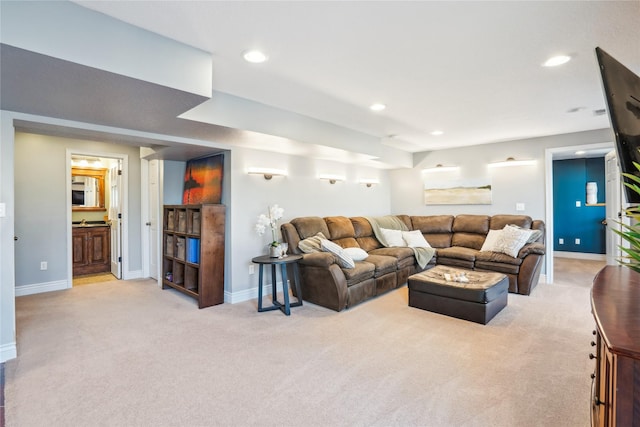 living room with recessed lighting, light colored carpet, and baseboards