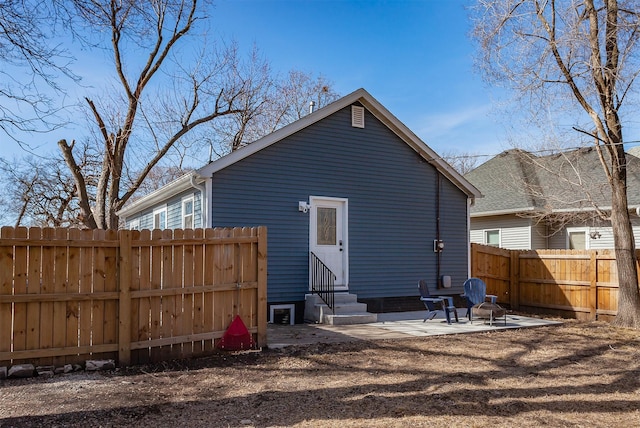 rear view of house featuring a patio area, fence, and entry steps