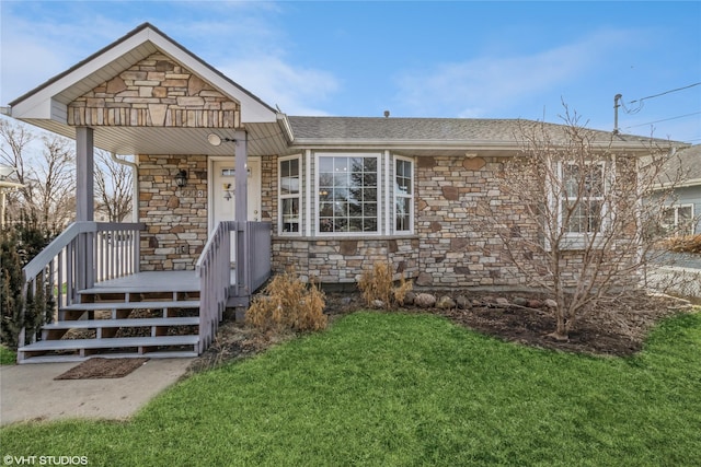 view of front of property featuring stone siding, covered porch, and a front yard